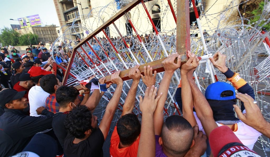 Protesters remove barriers during an anti-government demonstration against the provision of jobs and the alleged government corruption. Photo: dpa