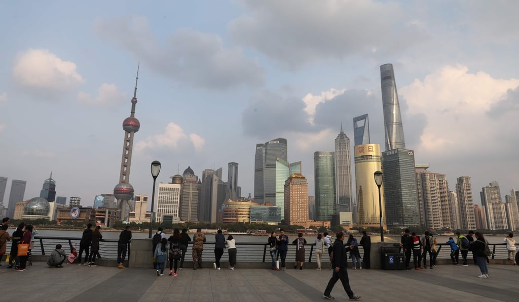 People walk at the Bund overlooking the financial district of Pudong in Shanghai. In the city’s actively traded office market, the vacancy level was 20 per cent. Photo: AFP