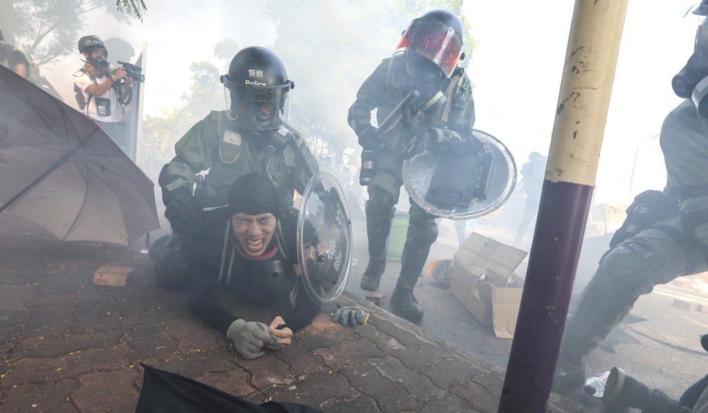 Riot police fire tear gas and arrest protesters outside Chinese University in Sha Tin early on Monday. Photo: Felix Wong Riot police fire tear gas and arrest protesters outside Chinese University in Sha Tin early on Monday. Photo: Felix Wong