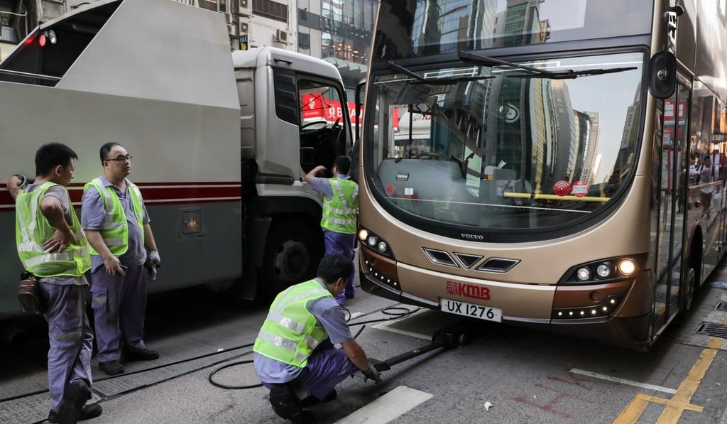 KMB staff servicing stalled buses in Mong Kok. Photo: Edmond So