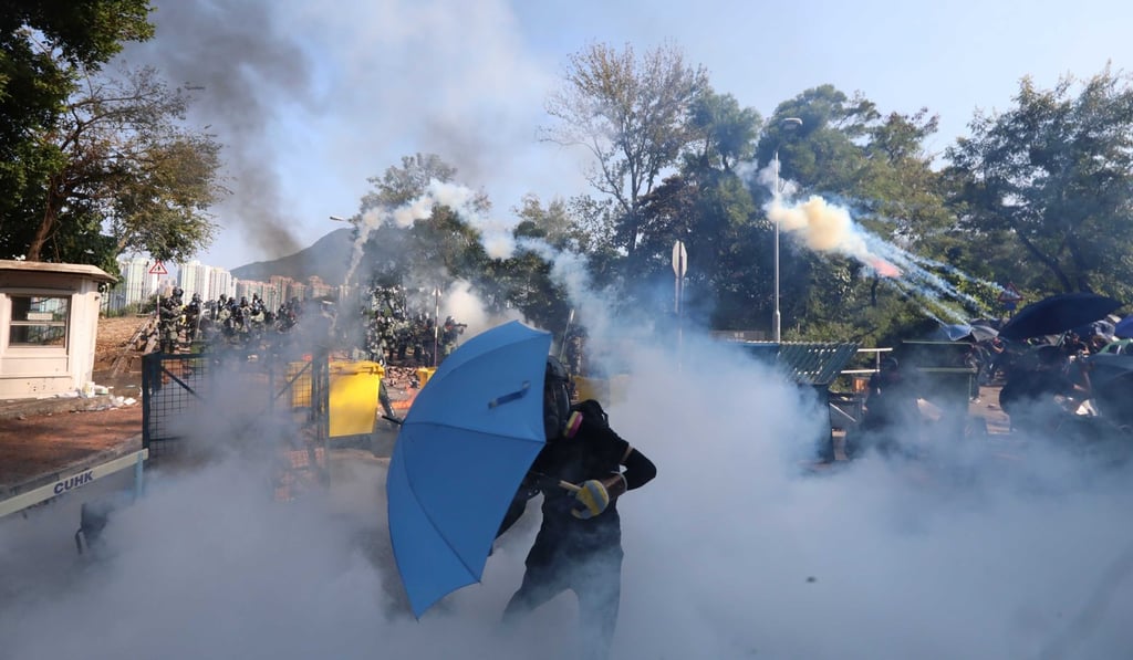 Riot police on Monday fire tear gas on Chinese University campus. Photo: Felix Wong