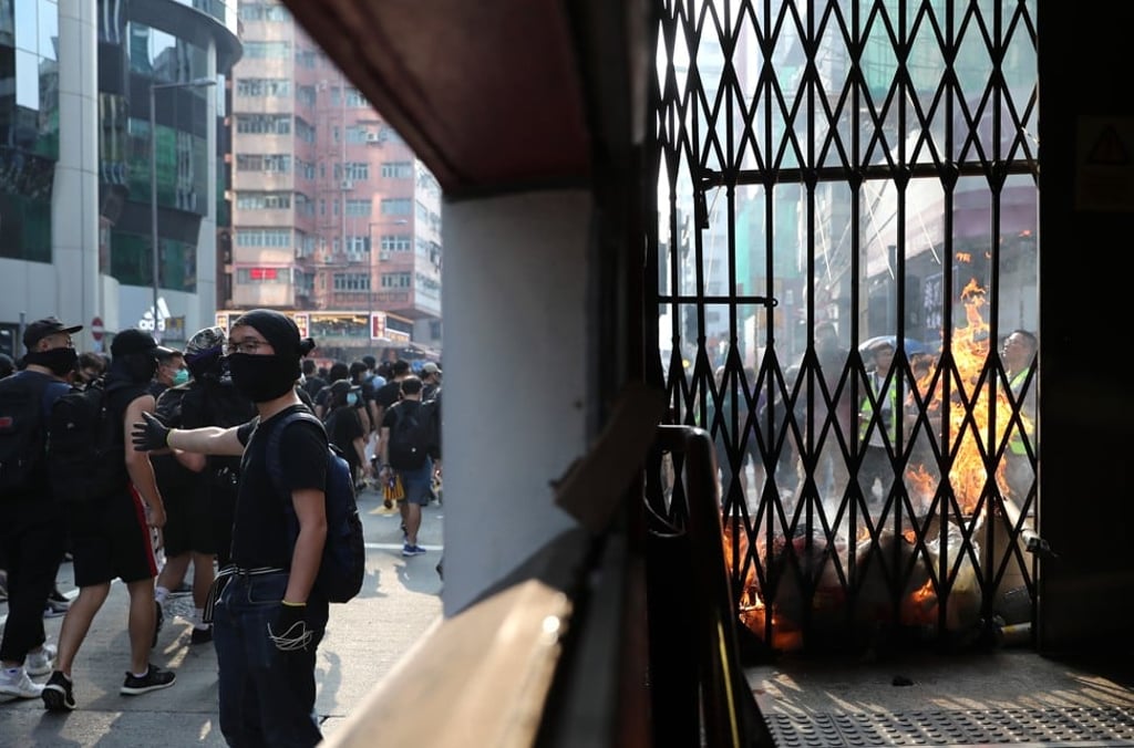 Anti-government protesters vandalise a MTR exit in Mong Kok on 20 October 2019. Photo: Sam Tsang