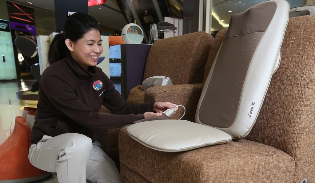 An OSIM sales consultant poses for a picture in Tsim Sha Tsui. Photo: Edmond So