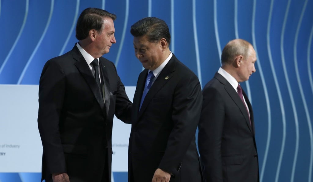 Brazil's President Jair Bolsonaro (left) greets China's President Xi Jinping next to Russia's President Vladimir Putin during the BRICS Business Council in Brasilia on Wednesday. Photo: AP Brazil's President Jair Bolsonaro (left) greets China's President Xi Jinping next to Russia's President Vladimir Putin during the BRICS Business Council in Brasilia on Wednesday. Photo: AP