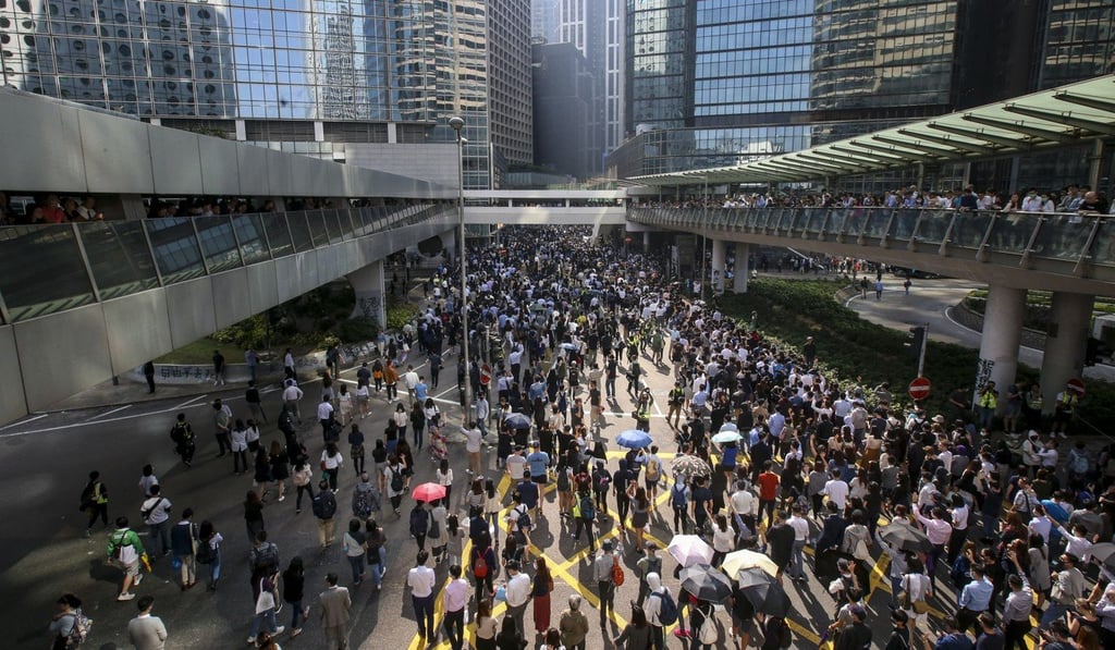 Protesters flood onto a road in Central during a lunchtime rally on Friday. Photo: David Wong