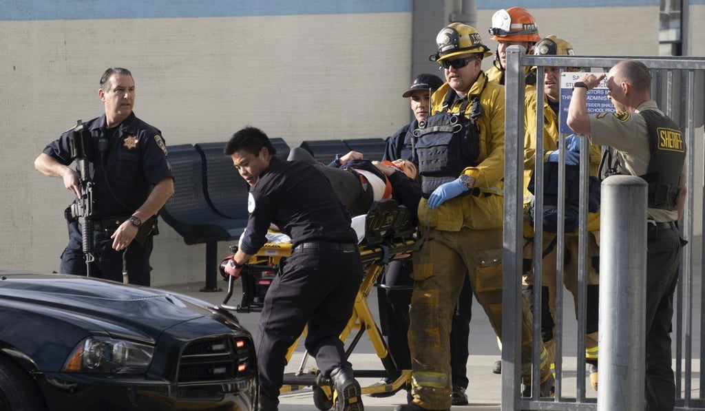 Emergency personnel remove an injured person following a shooting at Saugus High School on Thursday. Photo: Orange County Register via AP)