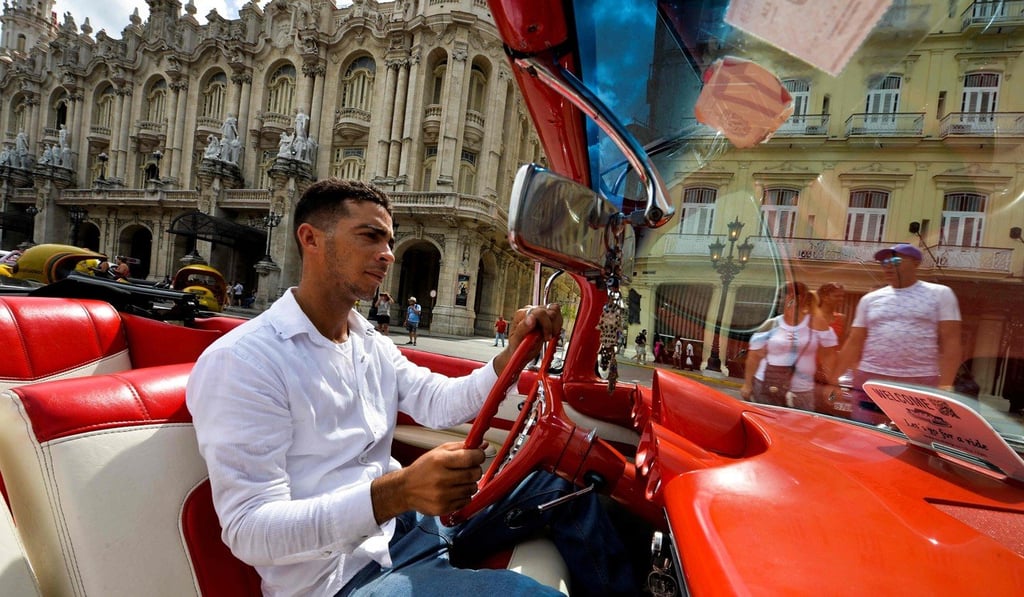 Yosbel Sosa, 33, drives tourists around the city’s historic sites in a black Chevrolet Impala with red and white seats. Photo: AFP Yosbel Sosa, 33, drives tourists around the city’s historic sites in a black Chevrolet Impala with red and white seats. Photo: AFP