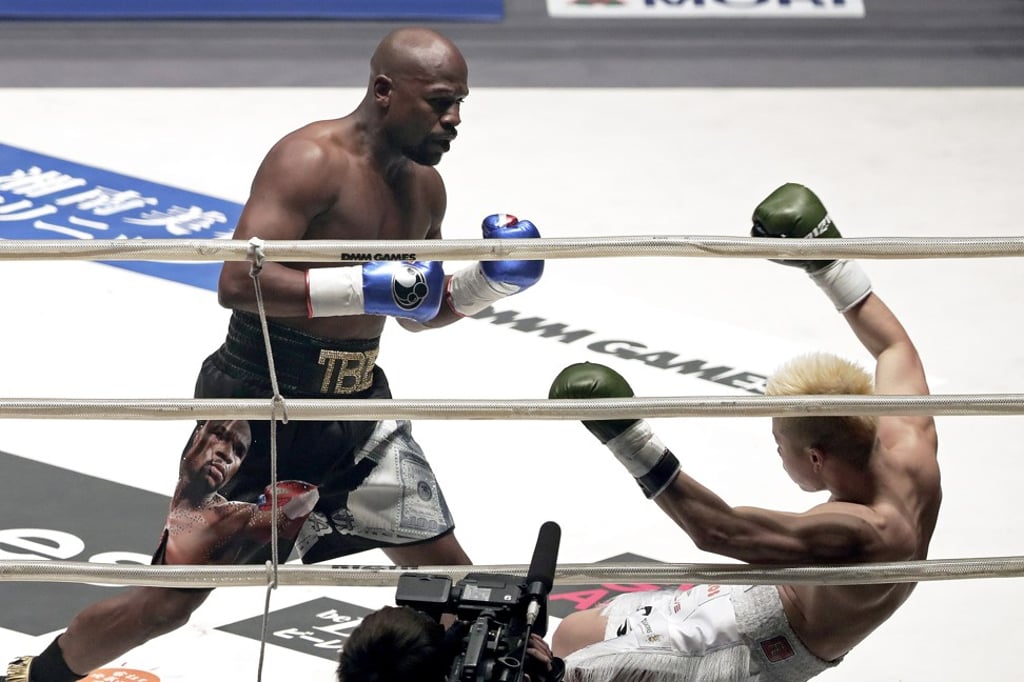 Floyd Mayweather Jnr knocks down Japanese kick-boxer Tenshin Nasukawa. Photo: EPA