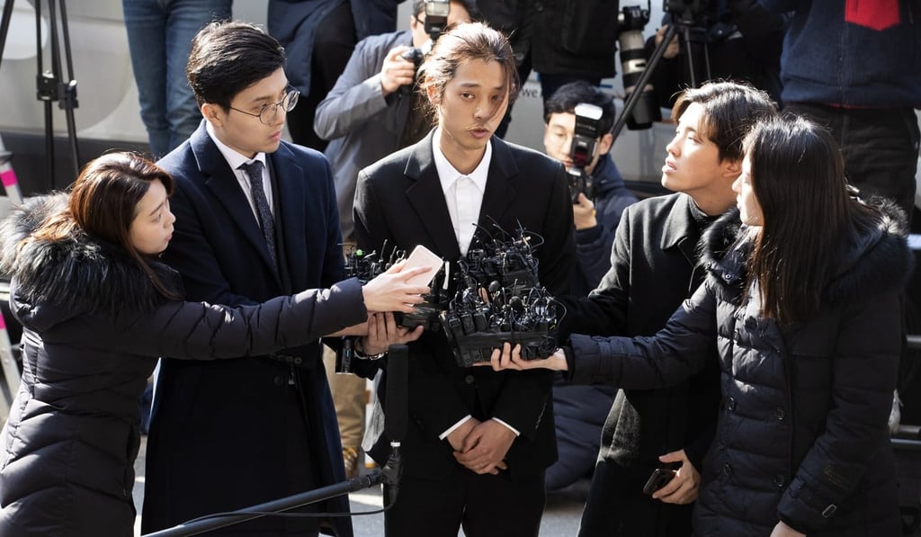 Jung Joon-young (centre) talks to reporters after arriving at the Metropolitan Police Agency in Seoul for questioning in March 2019. Photo: EPA-EFE via Yonhap