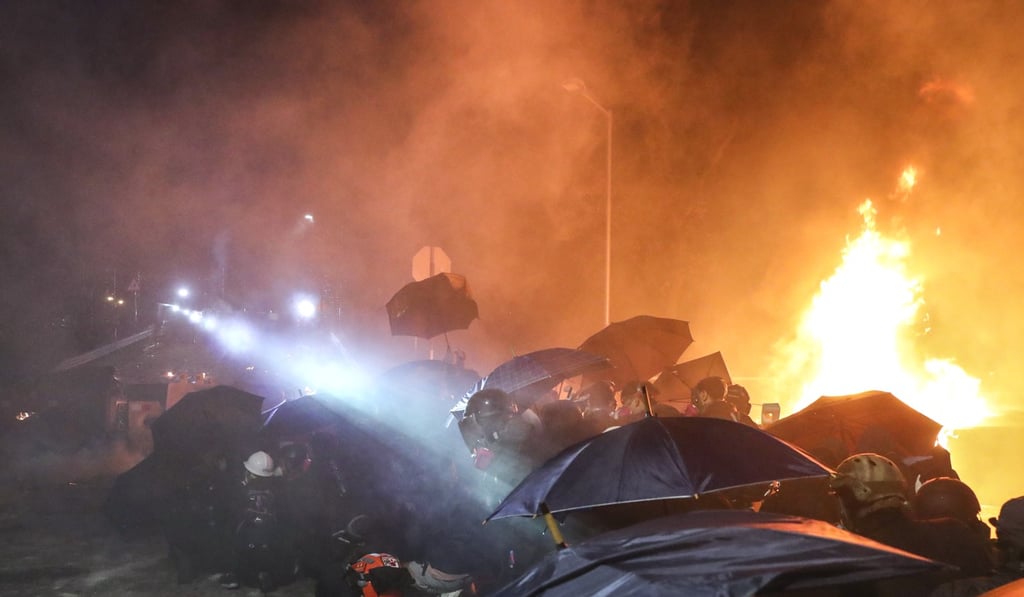 Protesters and police exchange petrol bombs and tear gas in a clash outside Chinese University. Photo: Sam Tsang Protesters and police exchange petrol bombs and tear gas in a clash outside Chinese University. Photo: Sam Tsang