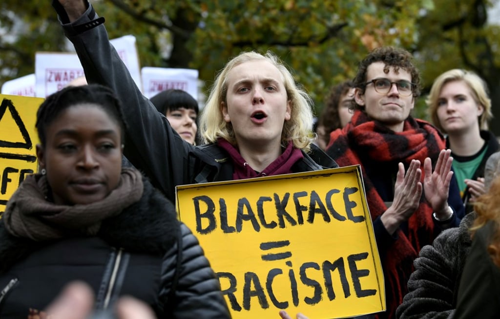 A protester holds a sign in a rally against the arrival of Saint Nicholas and his Black Pete assistants in The Hague, Netherlands, on November 16, 2019. Photo: Reuters A protester holds a sign in a rally against the arrival of Saint Nicholas and his Black Pete assistants in The Hague, Netherlands, on November 16, 2019. Photo: Reuters