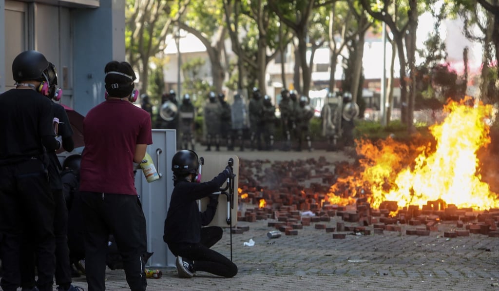 Protesters throw petrol bombs at police during clashes outside Polytechnic University. Photo: Winson Wong Protesters throw petrol bombs at police during clashes outside Polytechnic University. Photo: Winson Wong