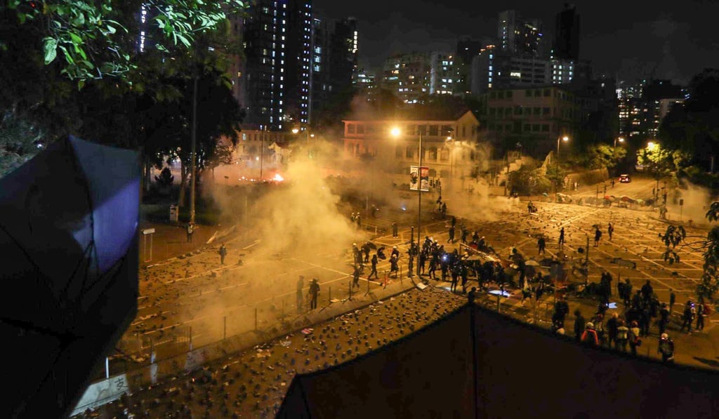 Police fire tear gas at protesters at the intersection of Chatham Road South and Austin Road outside Polytechnic University. Photo: Xiaomei Chen