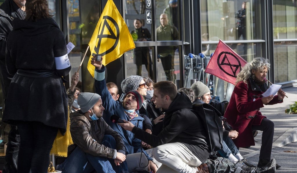 Extinction Rebellion climate change activists block an entrance to general aviation terminal at the Geneva Airport. Photo: EPA-EFE
