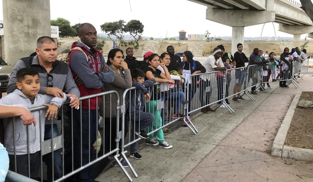 Asylum seekers in Tijuana, Mexico, listen to names being called from a waiting list to claim asylum at a border crossing in San Diego, in September 2019. File photo: AP Asylum seekers in Tijuana, Mexico, listen to names being called from a waiting list to claim asylum at a border crossing in San Diego, in September 2019. File photo: AP
