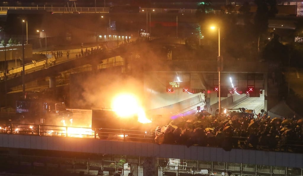 A police armoured vehicle was set on fire at a bridge near to the Cross-Harbour Tunnel in Hung Hom over the weekend in violence that has had a major impact on the airline industry. Photo: Sam Tsang