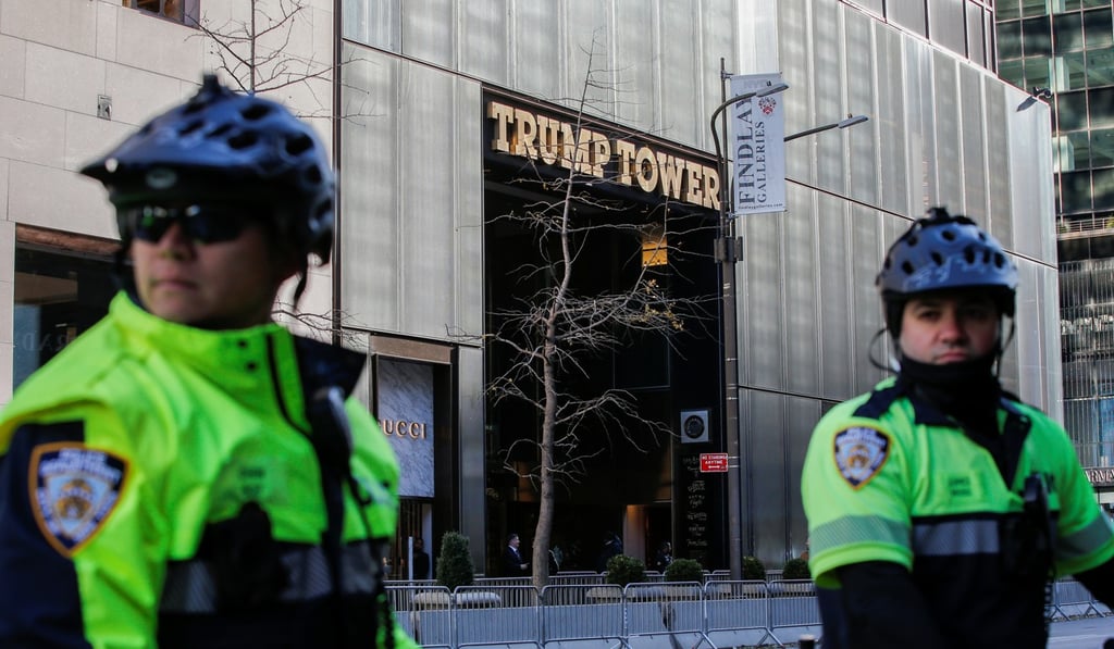 NYPD officers stand guard by their bicycles as demonstrators take part in a protest against US President Donald Trump and government policies near Trump Tower in Manhattan. Photo: Reuters
