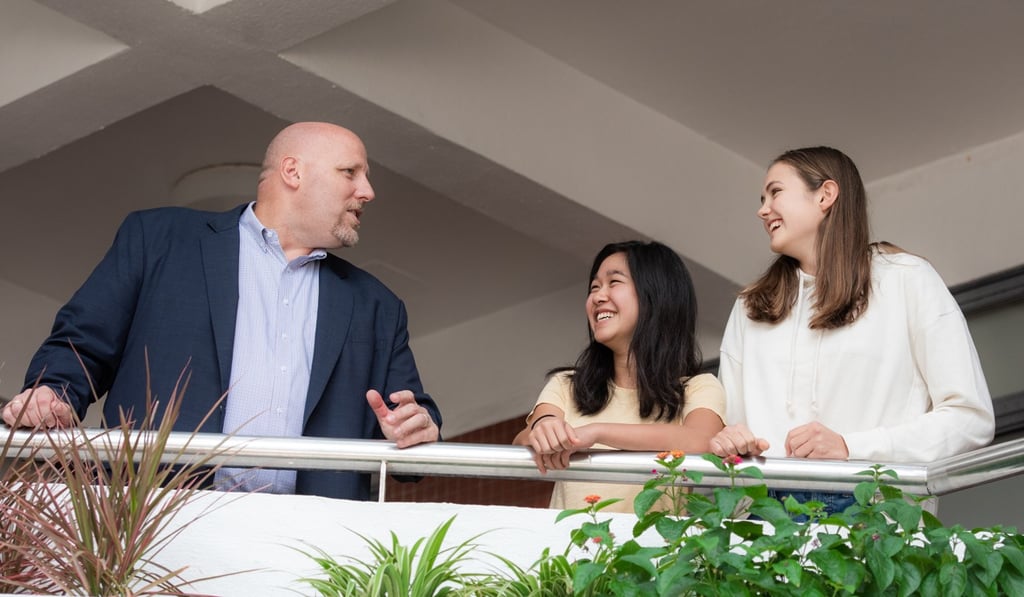 High school principal David Lovelin (left) chats to students at Hong Kong International School’s campus in Tai Tam.