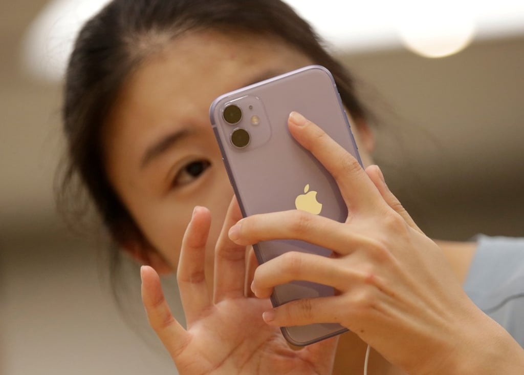 A customer tests Apple's iPhone 11 after it went on sale at the Apple Store in Beijing on September 20. Photo: Reuters