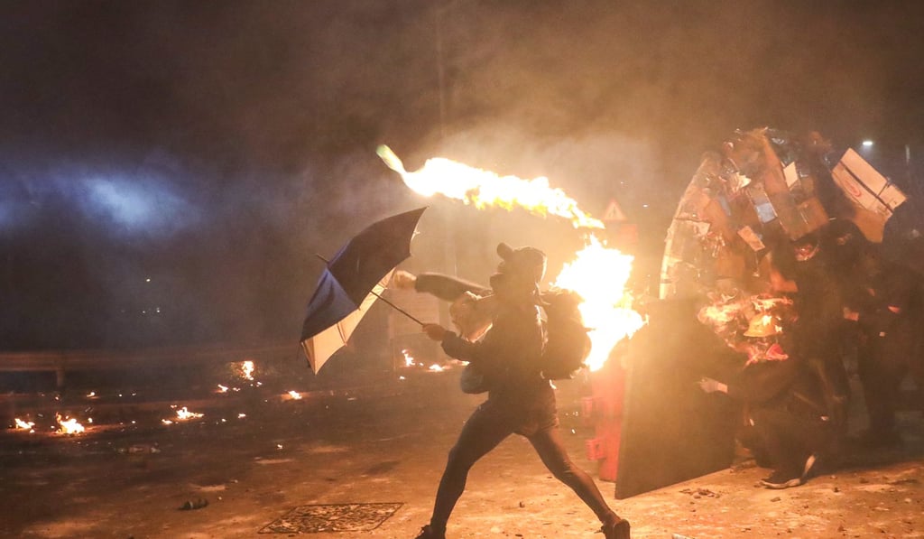 A protester throws a petrol bomb at police during a clash in Chinese University. Photo: Sam Tsang A protester throws a petrol bomb at police during a clash in Chinese University. Photo: Sam Tsang