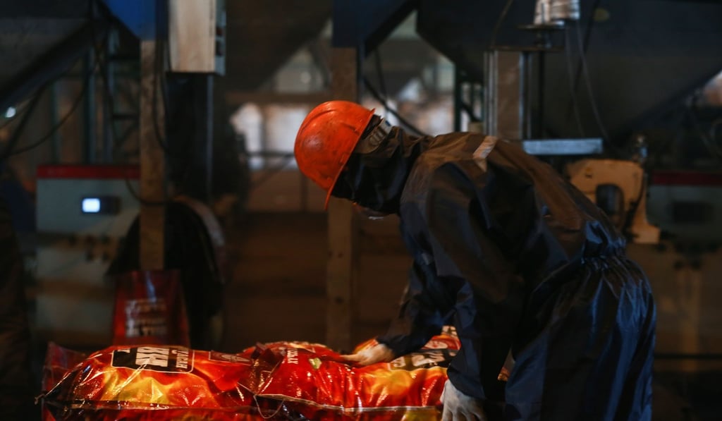 Employees at a factory producing smokeless fuel in Ulan Bator. Photo: AFP Employees at a factory producing smokeless fuel in Ulan Bator. Photo: AFP