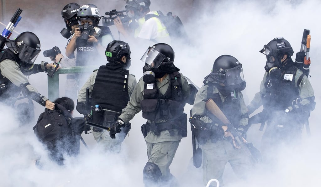 Riot police and protesters clash at PolyU. Photo: AP