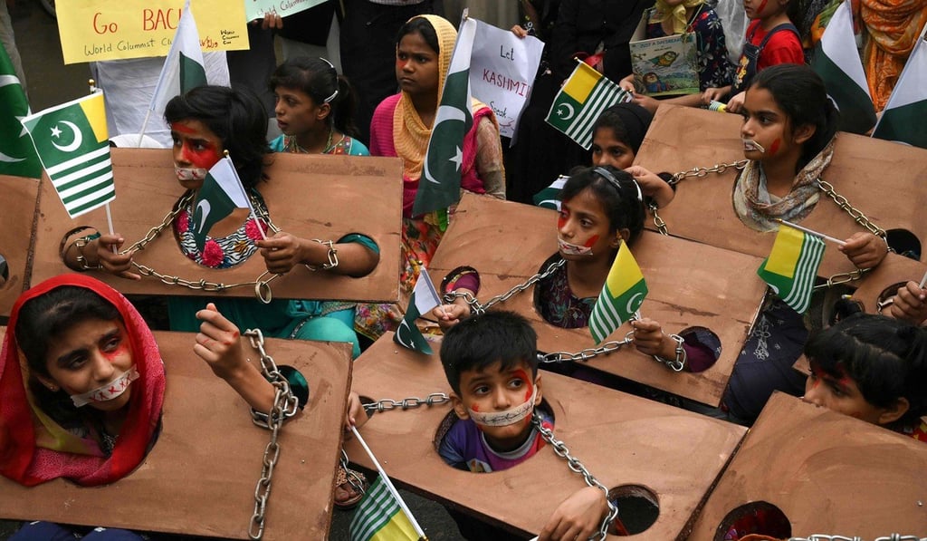 Children hold Kashmiri and Pakistani flags as they take part in an anti-India protest rally in Lahore. Photo: AFP