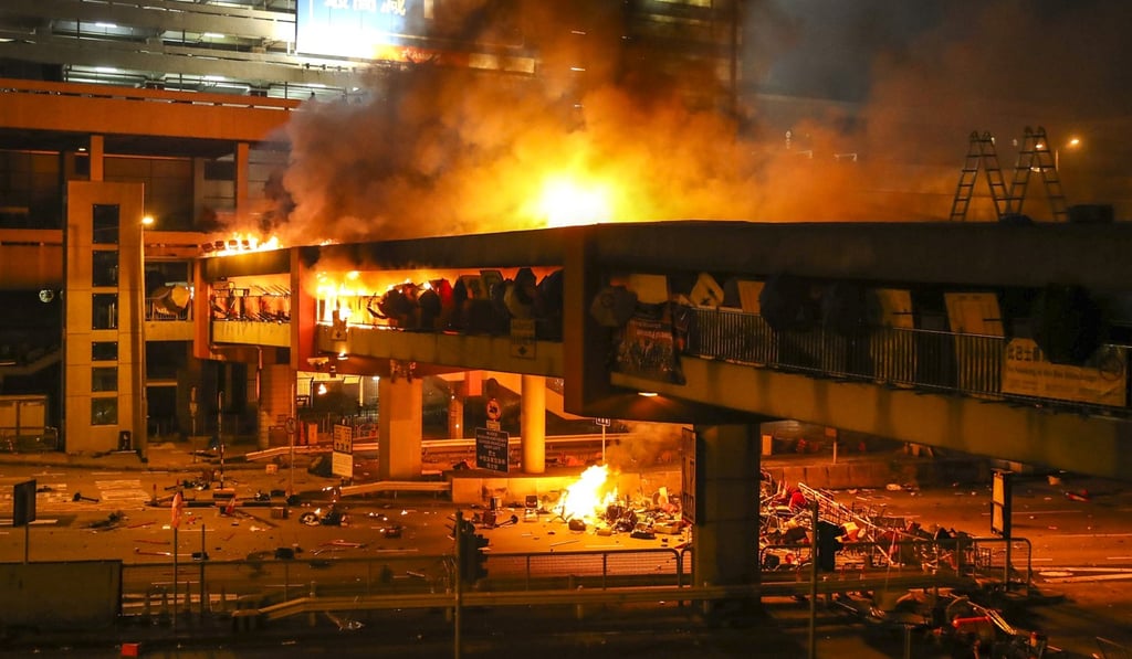 A massive fire breaks out on the footbridge connecting Hung Hom MTR station and PolyU as radicals clash with police. Photo: Winson Wong