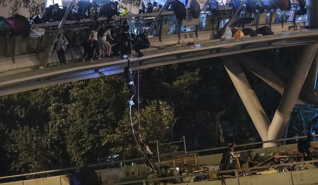 Several protesters find an escape route to a road outside Polytechnic University in Hung Hom. Photo: Felix Wong
