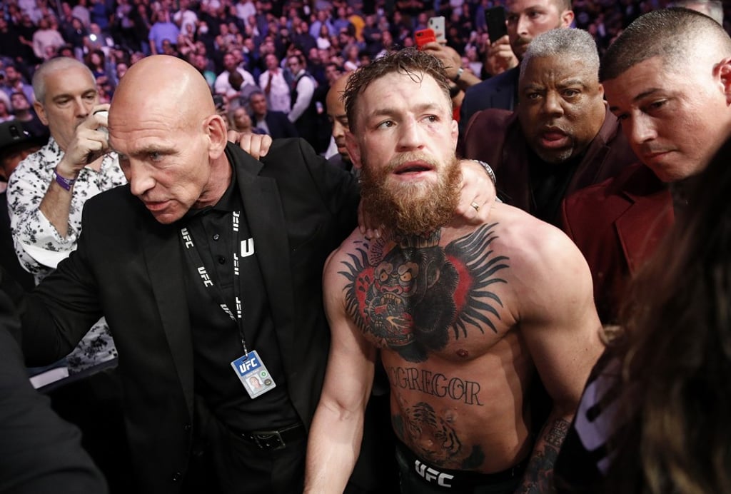 Conor McGregor is escorted from the Octagon after his UFC 229 main event against Khabib Nurmagomedov descended into a post-fight brawl. Photo: AP
