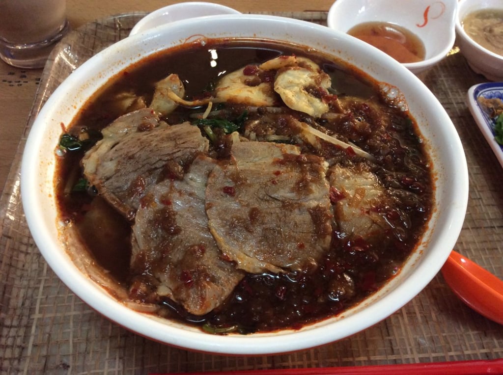 Spicy prawn noodle soup with prawn and sliced meat.