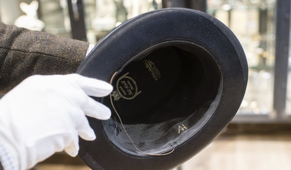 A man holds a hat with Adolf Hitler’s initials in Grasbrunn, Germany on Wednesday. Photo: dpa via AP A man holds a hat with Adolf Hitler’s initials in Grasbrunn, Germany on Wednesday. Photo: dpa via AP