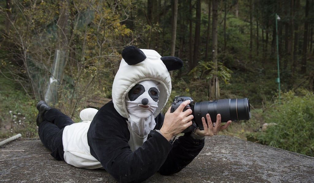 Ami Vitale dons a disguise while photographing pandas at the Hetaoping Wolong Panda Centre, in Sichuan province, China. Photo: courtesy of Ami Vitale