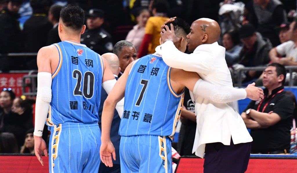 Former New York Knicks alumni Jeremy Lin (centre) and Stephon Marbury (right) embrace after a hard-fought Beijing derby. Photo: Xinhua
