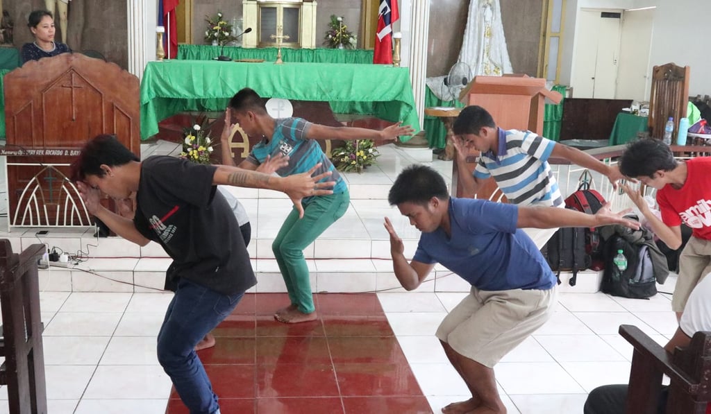 Members of Teatro Obrero practice one of their performance art pieces. Photo: Nick Aspinwall