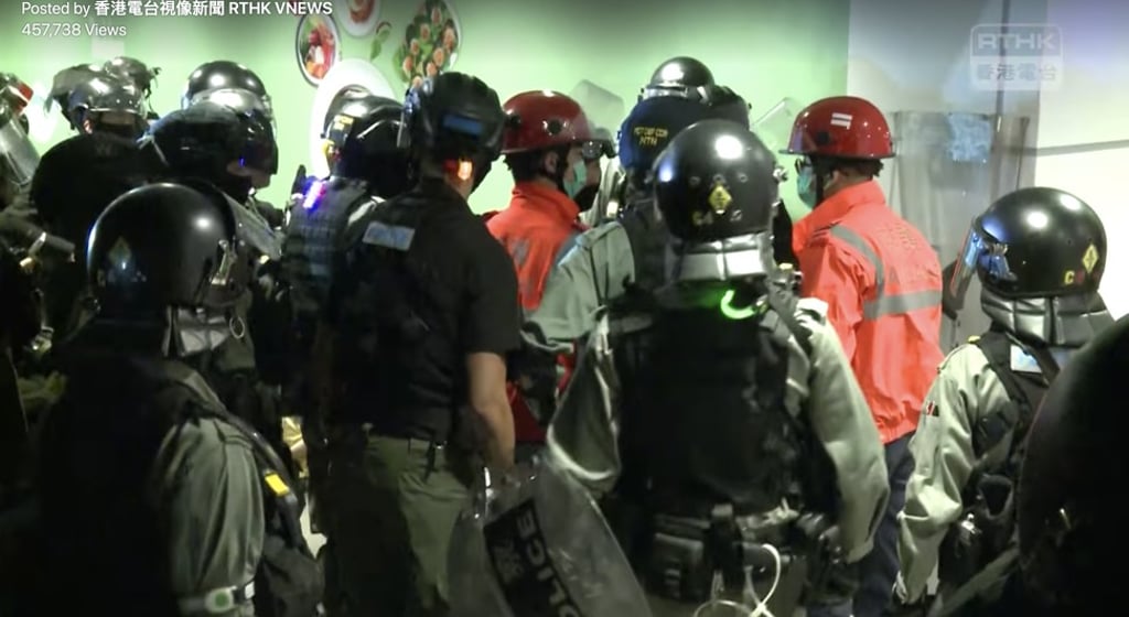 An argument breaks out between police and a paramedic from the Fire Services Department on November 8. Photo: RTHK