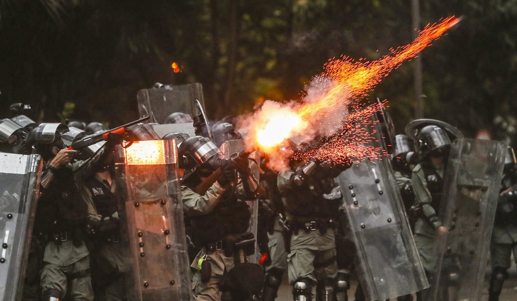 Riot police fire tear gas rounds at anti-government protesters in Admiralty. Photo: Sam Tsang