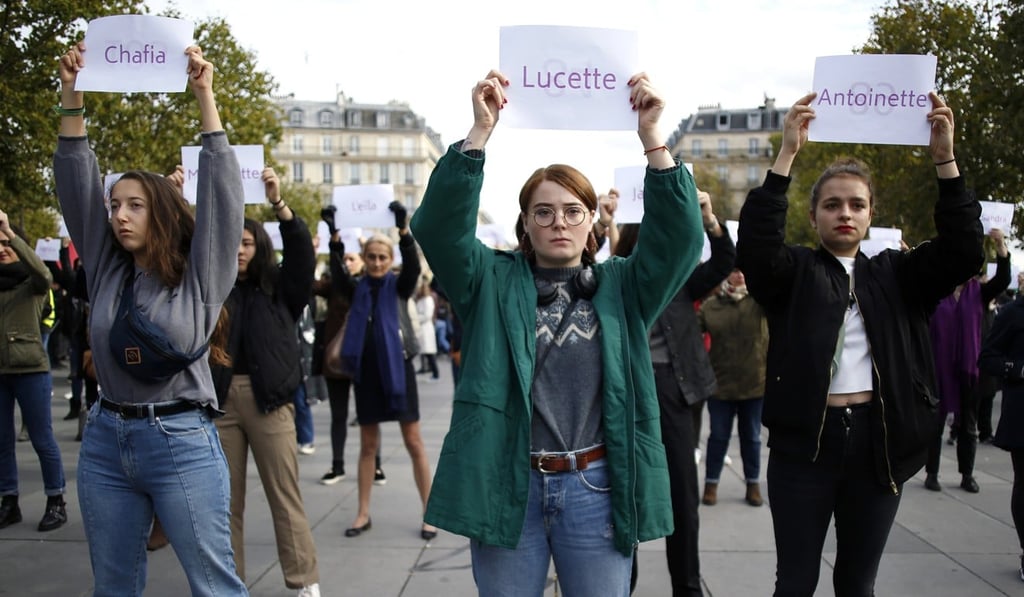Activists hold placards with the names of women killed by their partners during a protest in Paris. Photo: AP