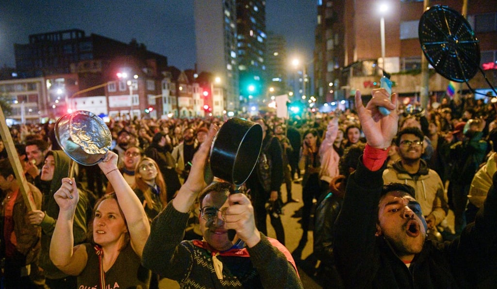 People bang pots and pans in a clamorous protest known as a cacerolazo in Bogota. Photo: AFP People bang pots and pans in a clamorous protest known as a cacerolazo in Bogota. Photo: AFP