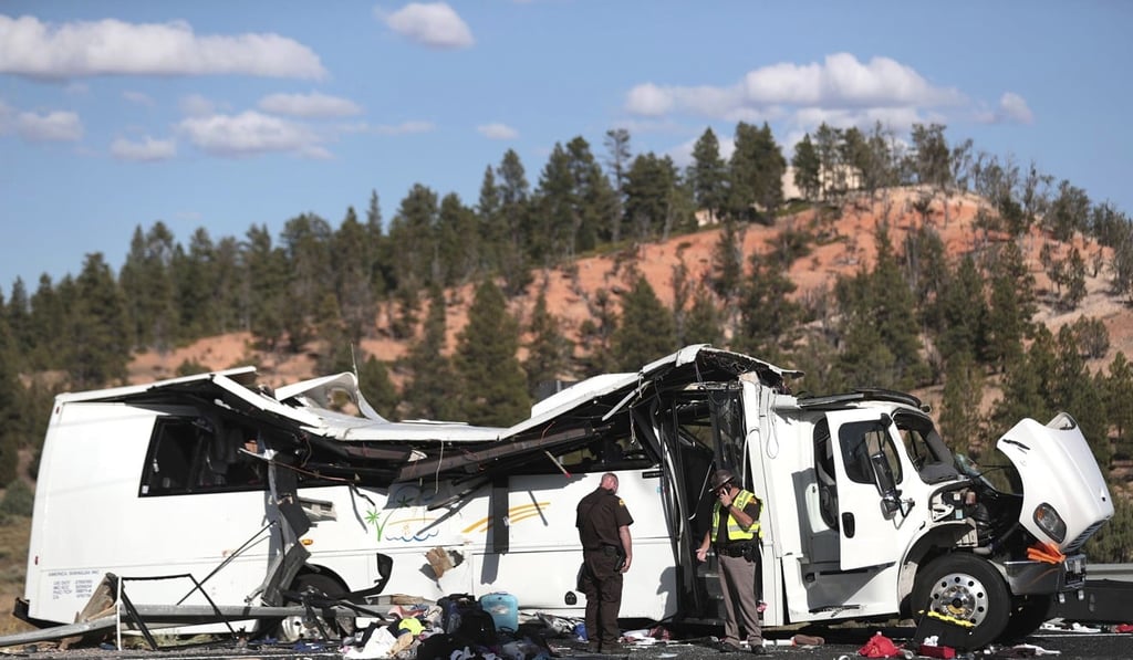 Authorities work the scene where at least four people were killed in a tour bus crash near Bryce Canyon National Park in Utah. Photo: The Deseret News via AP Authorities work the scene where at least four people were killed in a tour bus crash near Bryce Canyon National Park in Utah. Photo: The Deseret News via AP