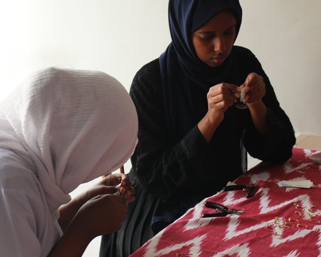 Refugee girls working on Fugeelah jewellery.