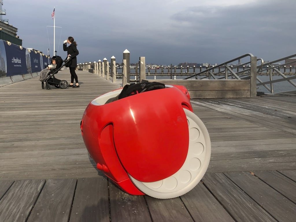 A cargo-carrying robot called the Gita sits near a waterfront park in Boston. A subsidiary of Italian carmaker Piaggio designed the machine to follow its owner, while carrying groceries and other items. Photo: AP A cargo-carrying robot called the Gita sits near a waterfront park in Boston. A subsidiary of Italian carmaker Piaggio designed the machine to follow its owner, while carrying groceries and other items. Photo: AP