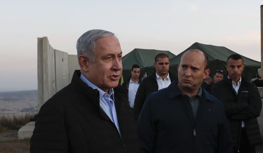 Israeli Prime Minister Benjamin Netanyahu left, and Defence Minister Naftali Bennett, second right, visit an Israeli army base in the Golan Heights. Photo: Pool via AP Israeli Prime Minister Benjamin Netanyahu left, and Defence Minister Naftali Bennett, second right, visit an Israeli army base in the Golan Heights. Photo: Pool via AP