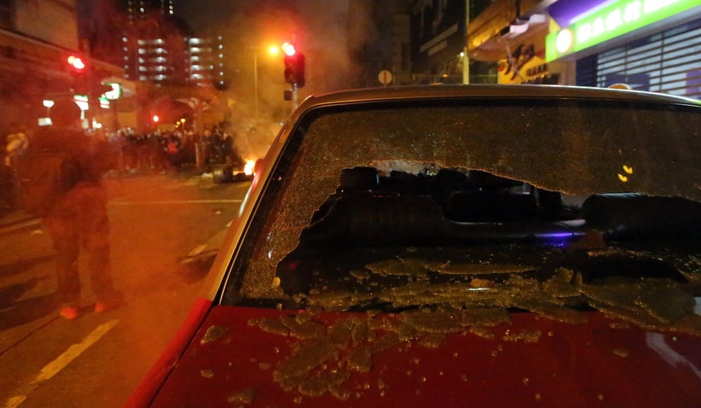 A damaged taxi is seen during clashes in Mong Kok on February 9, 2016. Photo: Edward Wong