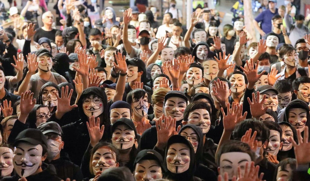 Anti-government protesters have repeatedly shown their willingness to flout the mask ban, including those wearing Guy Fawkes masks in Tsim Sha Tsui on November 5. Photo: Felix Wong