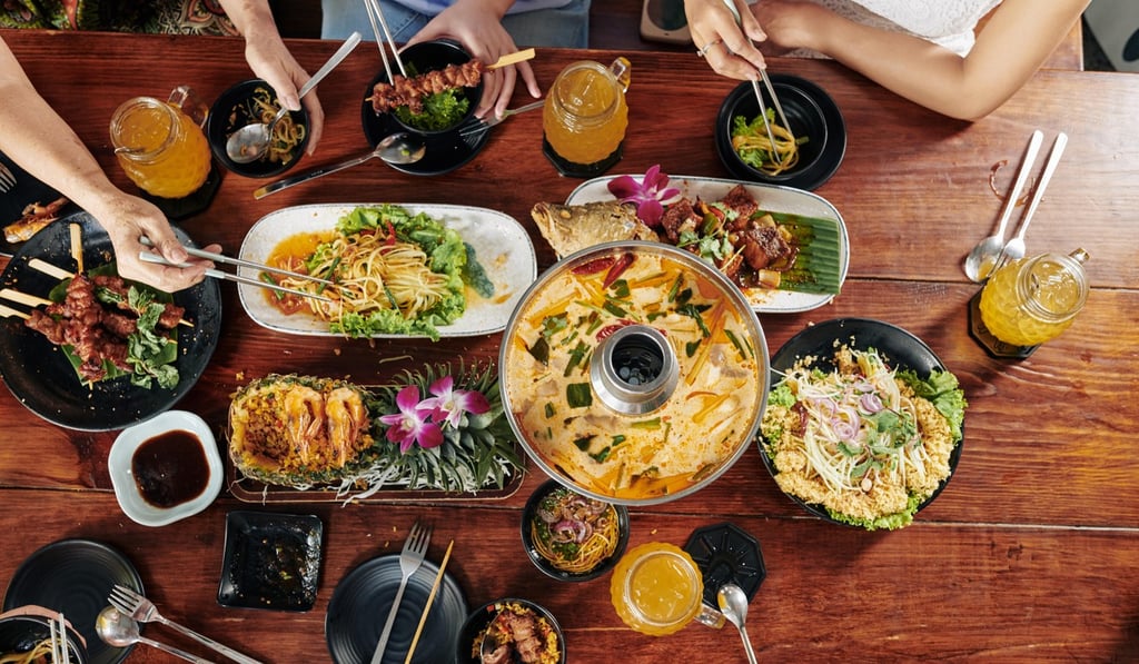 Studies show that people eat more when they’re with their family or friends. Photo: Alamy