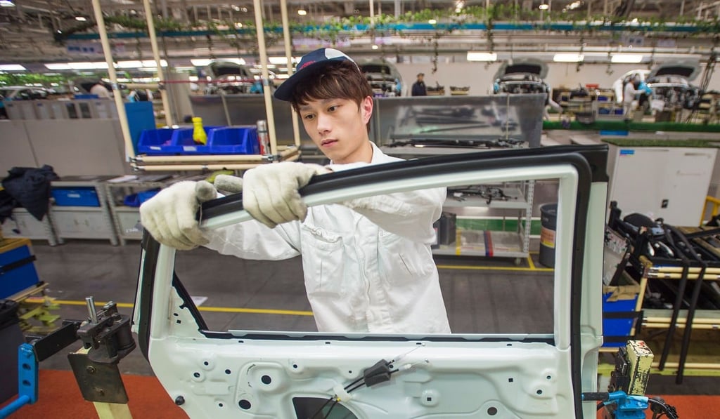 A Dongfeng Honda employee works on the Civic production line at the carmaker’s factory in Wuhan, Hubei province. Photo: AFP