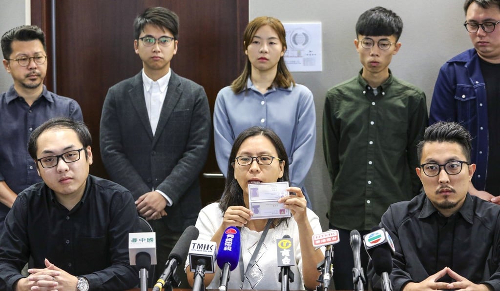 Beaten candidates (front row, from left) Lee Kan-ming, Lucia Chiu, and Law Ting-fai, announce their intention to challenge the results of the district council elections. Photo: May Tse