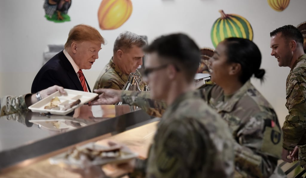 US President Donald Trump serves Thanksgiving dinner to US troops at Bagram Airfield during a surprise visit on Thursday. Photo: AFP