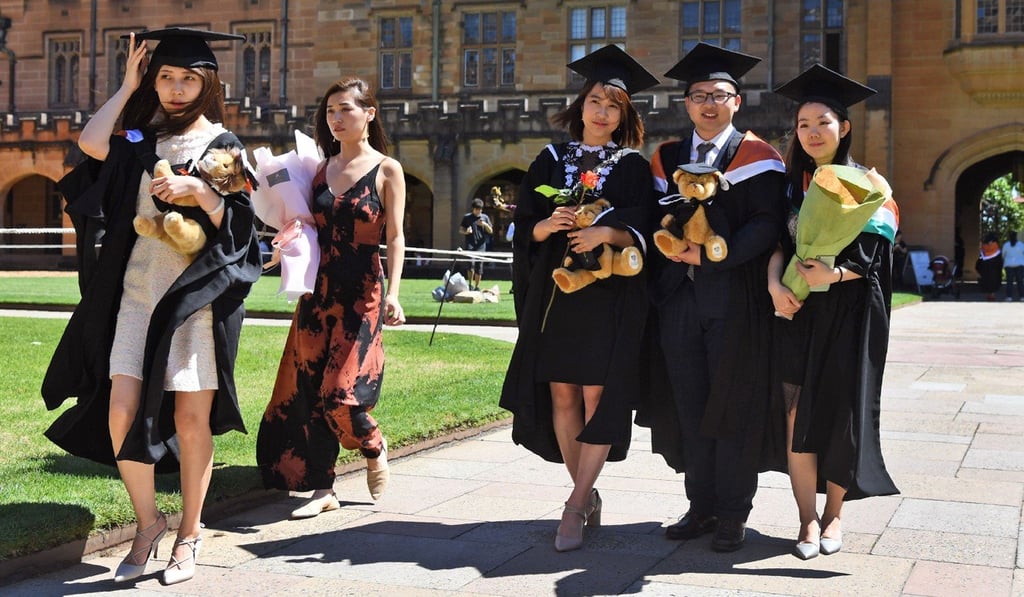 Students from China pose for photos after graduating from the University of Sydney in October 2017. Cities which draw a large number of international students need to meet the growing demand for purpose-built student housing. Photo: AFP